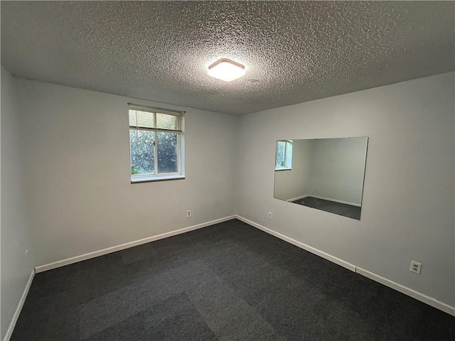 unfurnished room featuring a textured ceiling and carpet flooring