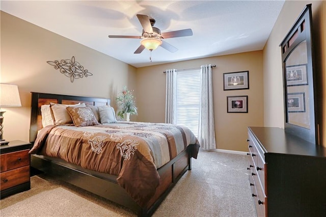 bedroom featuring light carpet and ceiling fan