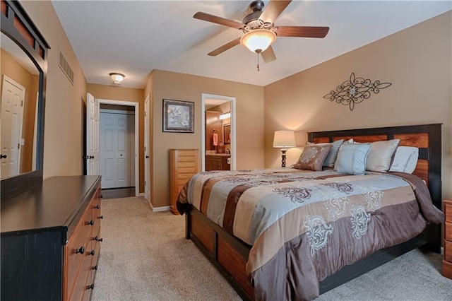 carpeted bedroom with ceiling fan and connected bathroom