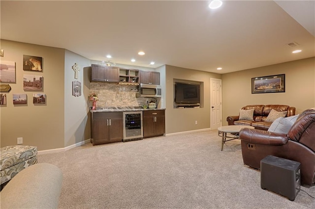 living room featuring light carpet, wine cooler, and bar