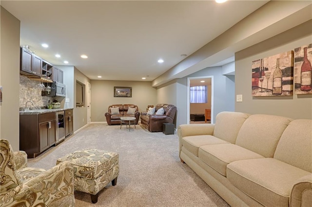 living room featuring indoor wet bar, light colored carpet, and beverage cooler