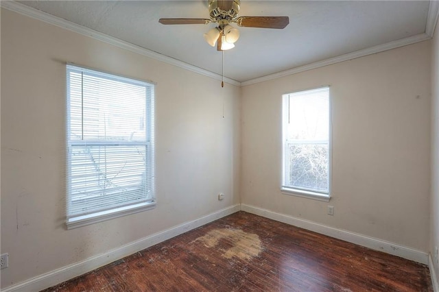 empty room featuring baseboards, ceiling fan, wood finished floors, and crown molding