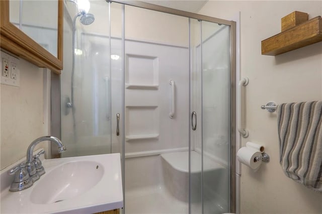 bathroom featuring a stall shower and vanity