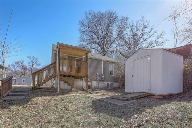 exterior space featuring a deck, cooling unit, a storage shed, an outdoor structure, and stairway