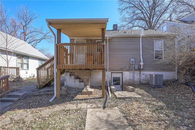 back of property featuring stairway, cooling unit, a chimney, and a wooden deck