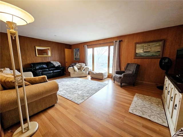 living area with wood walls and light wood finished floors