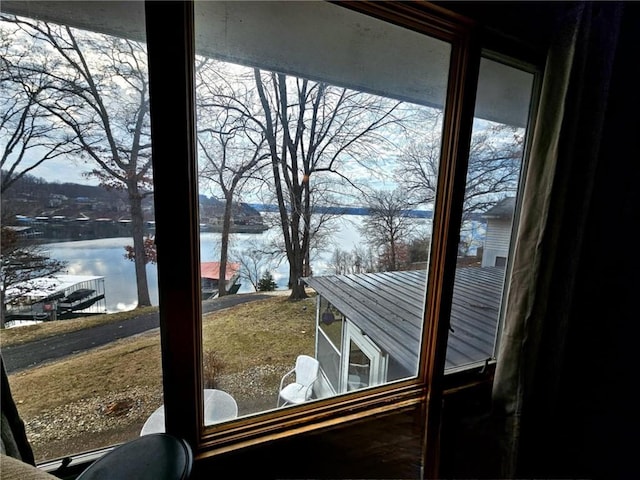 interior space with a water view and a healthy amount of sunlight