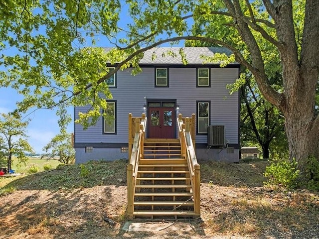 back of house featuring stairway, central AC unit, and a wooden deck