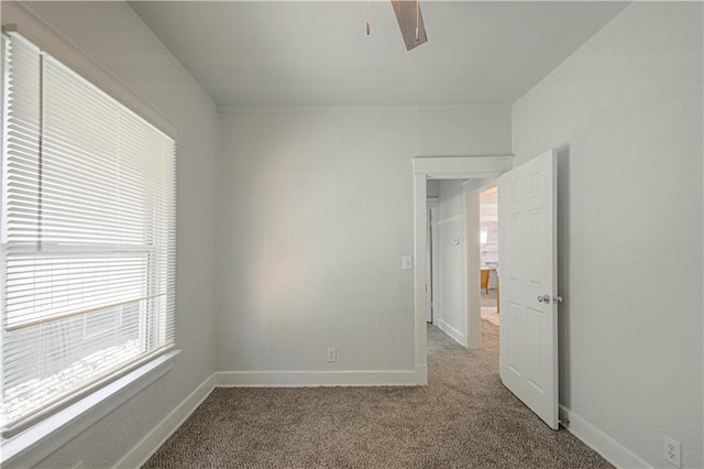 empty room with carpet flooring and baseboards