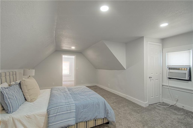 bedroom featuring baseboards, lofted ceiling, cooling unit, a textured ceiling, and carpet floors