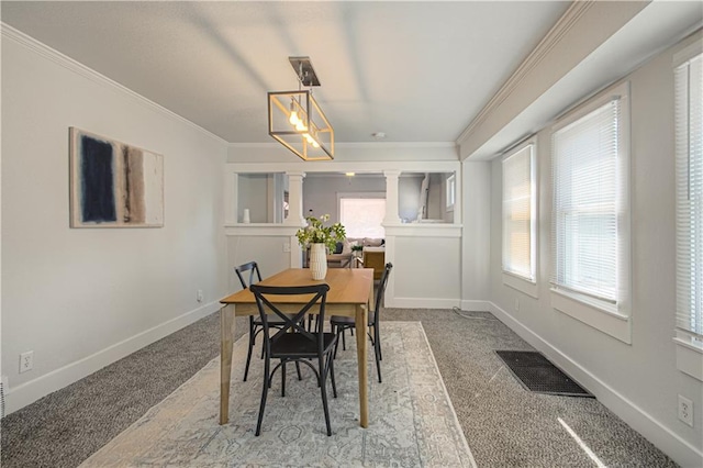 3946 Flora Ave, Kansas City, MO 64110 - dining area with baseboards, carpet flooring, ornamental molding, and visible vents