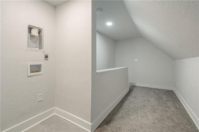 3946 Flora Ave, Kansas City, MO 64110 - interior space with a textured wall, baseboards, lofted ceiling, and a textured ceiling
