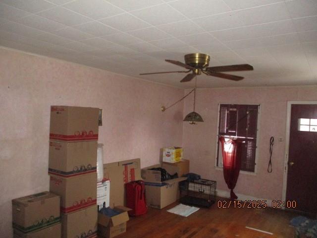 interior space with ceiling fan and wood finished floors