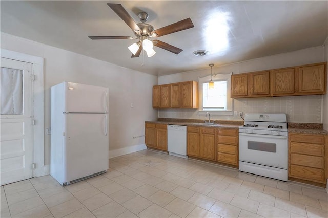kitchen with ceiling fan, white appliances, visible vents, a sink, and brown cabinets