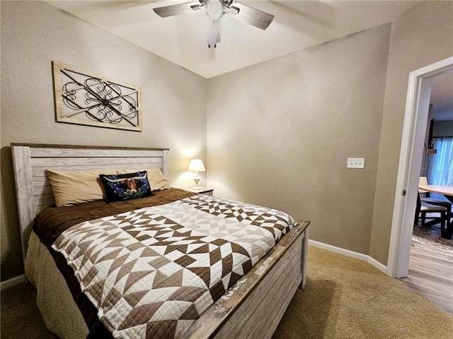 bedroom with a ceiling fan, carpet, and baseboards