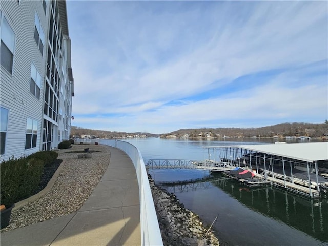 view of property's community featuring a water view and a floating dock