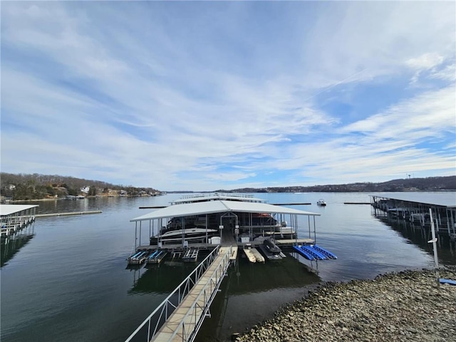 dock area with a water view and boat lift