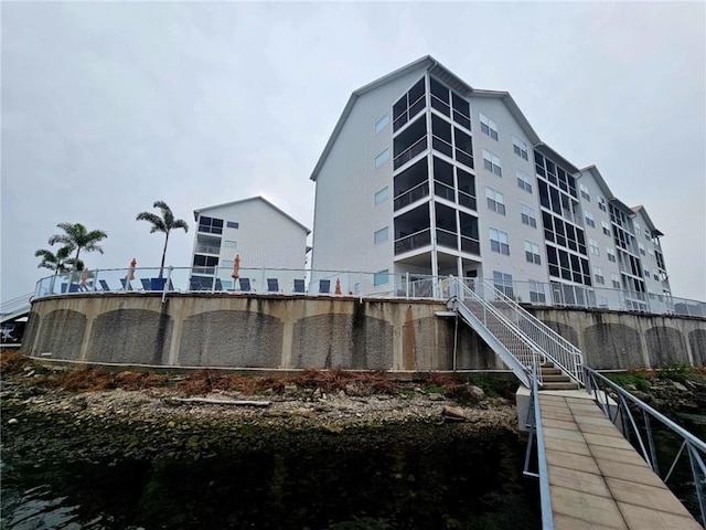 exterior space featuring a water view and stairs