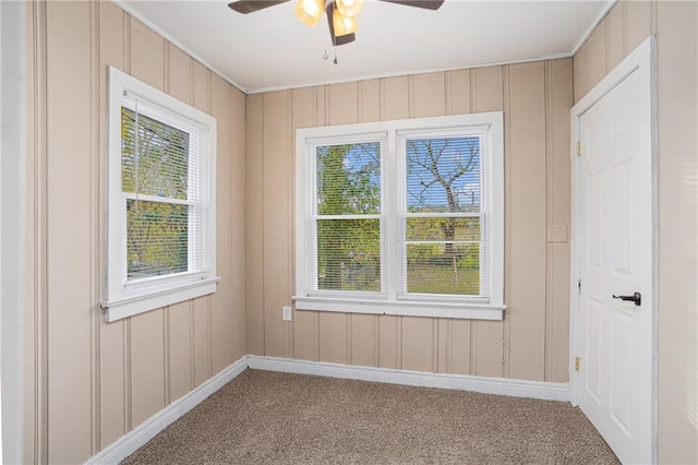 empty room featuring ceiling fan and carpet floors