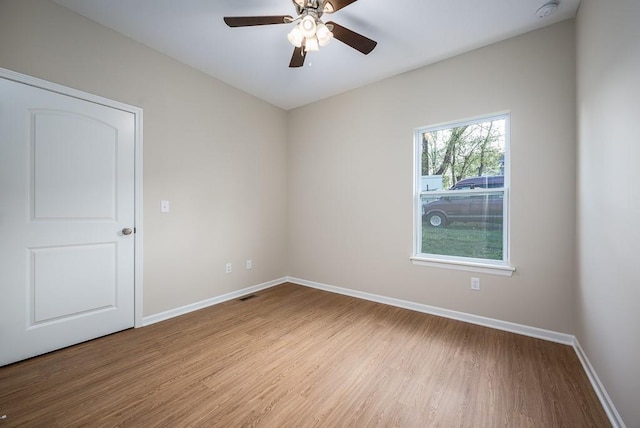 908 2nd St, Perry, KS 66073 - unfurnished room with wood finished floors, a smoke detector, baseboards, and ceiling fan