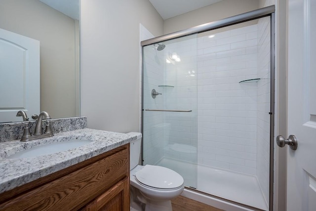 908 2nd St, Perry, KS 66073 - bathroom with a stall shower, toilet, vanity, and wood finished floors