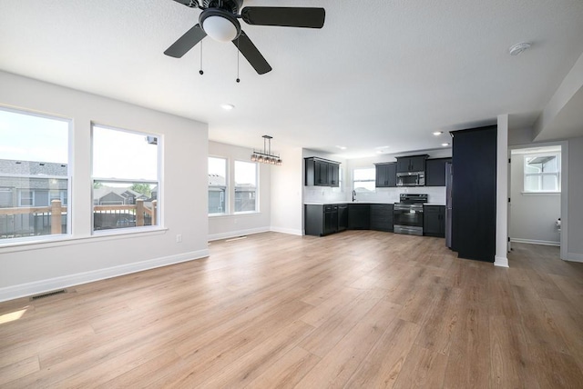 unfurnished living room with light hardwood / wood-style flooring and ceiling fan