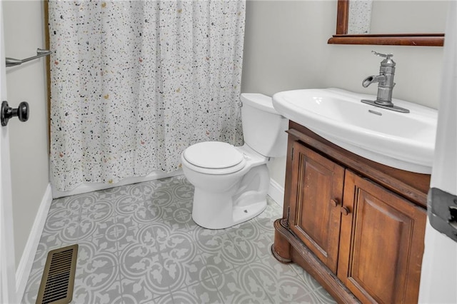 bathroom with curtained shower, toilet, vanity, visible vents, and tile patterned floors