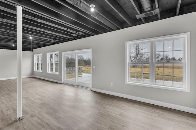 interior space featuring baseboards and wood finished floors