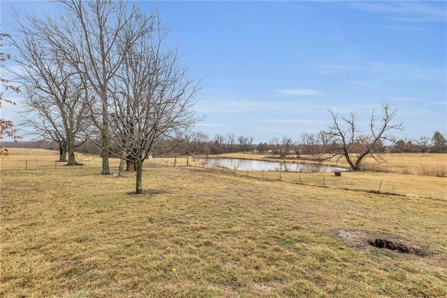 view of yard featuring a water view and a rural view