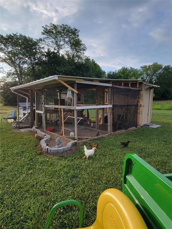 view of poultry coop with a yard