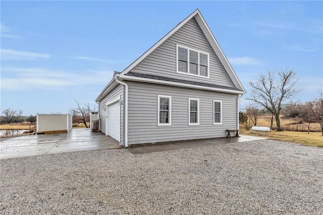 view of home's exterior featuring a garage and driveway