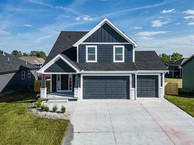 view of front of house featuring driveway, a porch, board and batten siding, a shingled roof, and a front yard