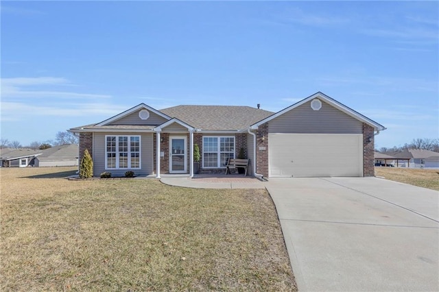 single story home with a garage, concrete driveway, brick siding, and a front yard