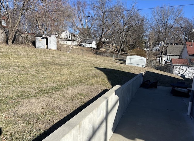 view of yard with an outbuilding, a shed, and a fenced backyard