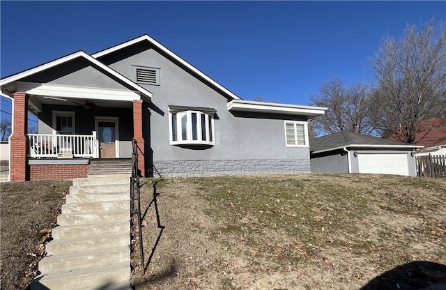 view of front of house featuring a garage, ceiling fan, a porch, and stucco siding