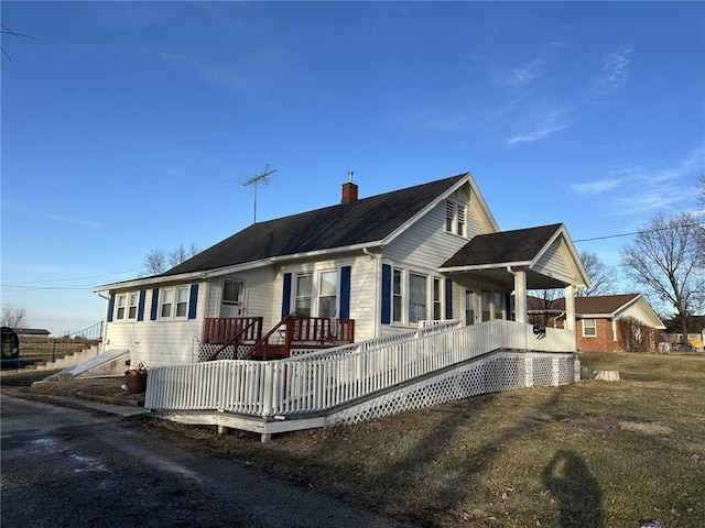 view of front facade with a deck and a chimney