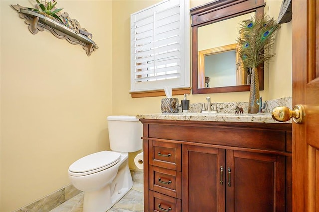 bathroom with toilet and vanity