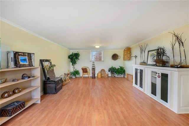 sitting room featuring crown molding and light wood-style floors