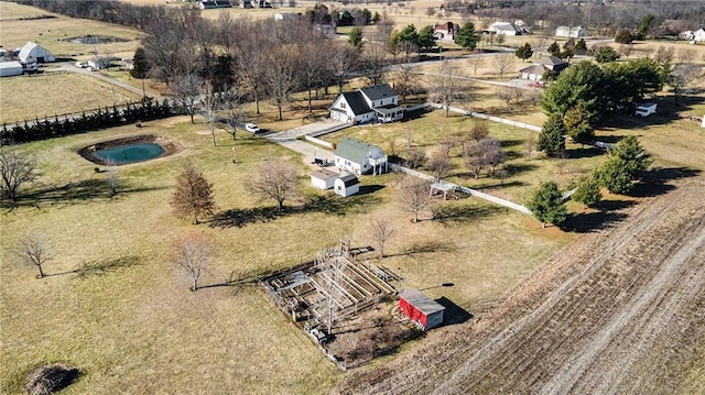 birds eye view of property with a rural view