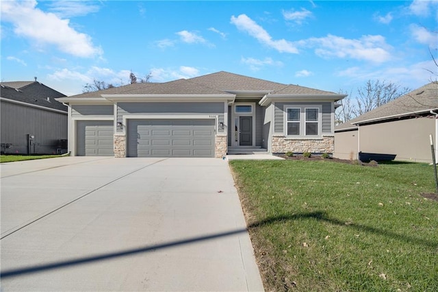 view of front of house featuring a garage and a front lawn