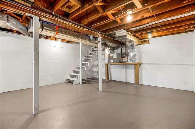 unfinished basement featuring stairway