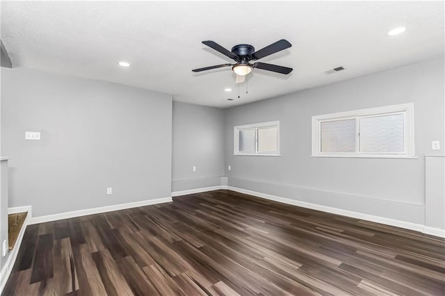 spare room featuring ceiling fan, baseboards, dark wood-type flooring, and recessed lighting