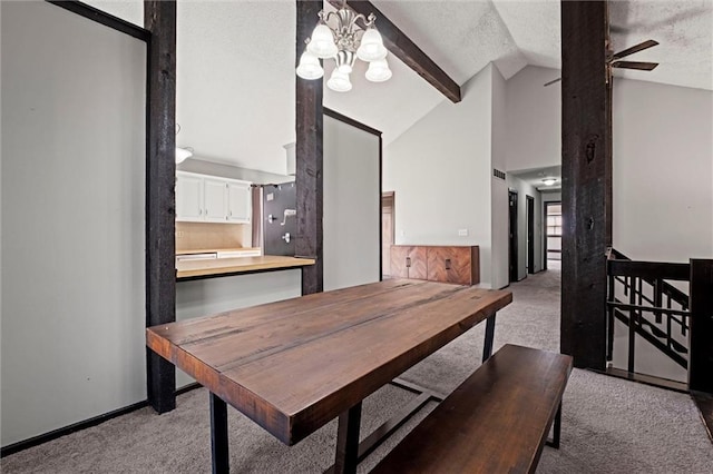 dining space with lofted ceiling, ceiling fan with notable chandelier, a textured ceiling, and light colored carpet