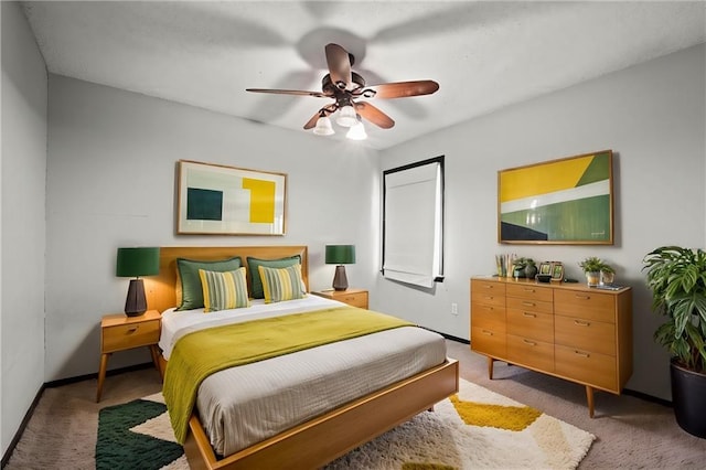 carpeted bedroom featuring a ceiling fan and baseboards