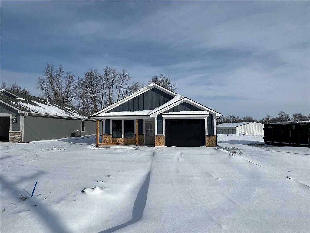 craftsman-style home with board and batten siding, a porch, and a garage