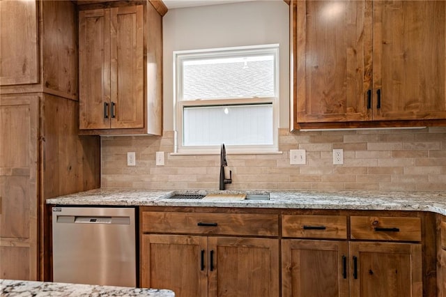 607 W Dryden St, Odessa, MO 64076 - kitchen with decorative backsplash, brown cabinets, stainless steel dishwasher, and a sink