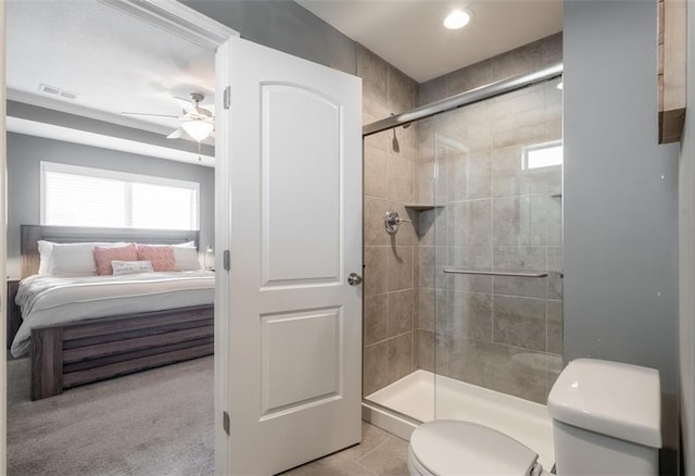 bathroom with visible vents, toilet, a ceiling fan, a stall shower, and connected bathroom