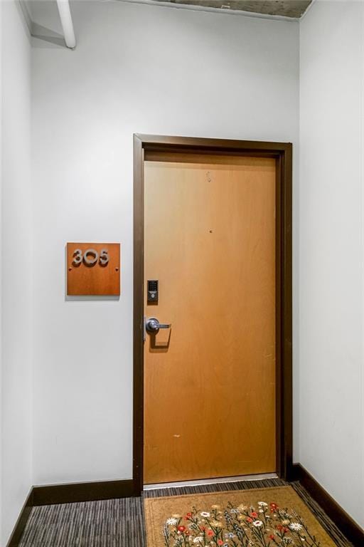 doorway featuring baseboards