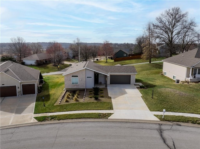 view of front facade featuring a residential view, driveway, an attached garage, and a front lawn