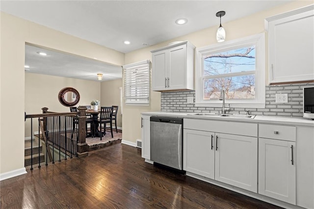 kitchen featuring tasteful backsplash, a wealth of natural light, a sink, and stainless steel dishwasher